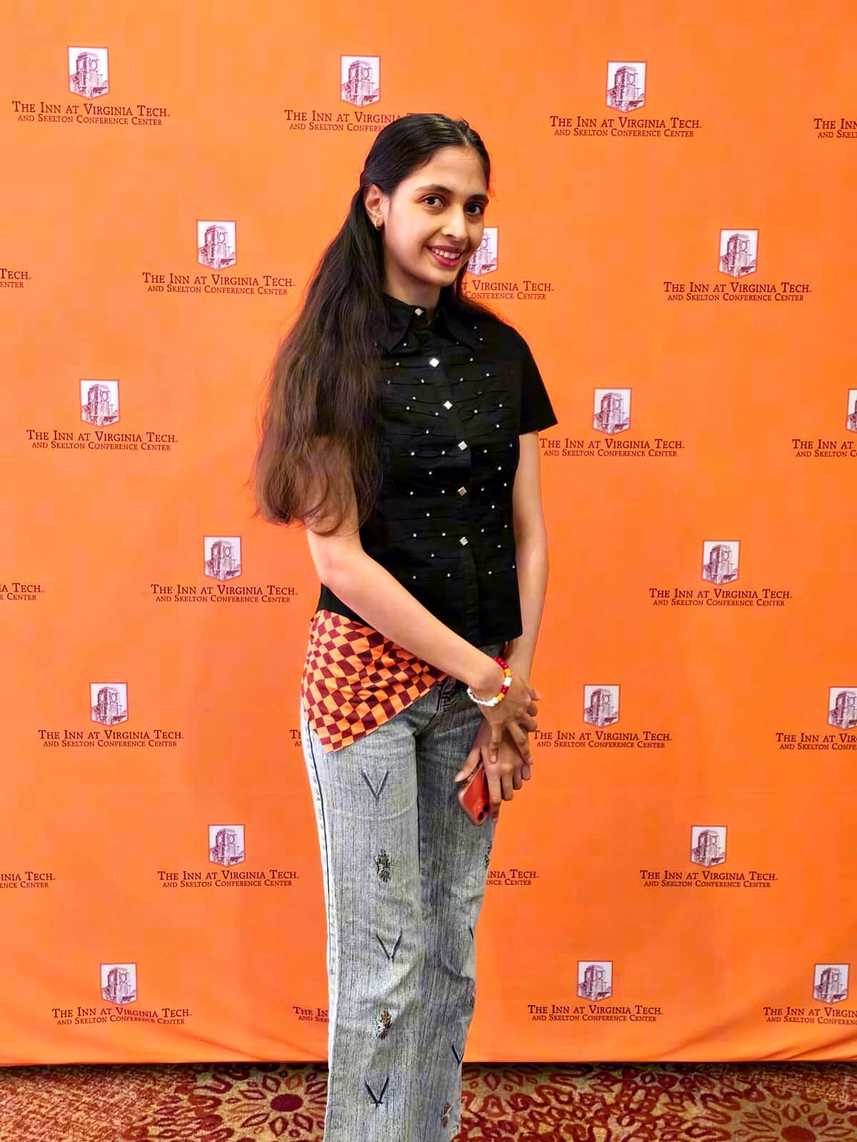 Kinjal Pandey at a Virginia Tech scholarship recognition event, photographed against the Inn at Virginia Tech backdrop