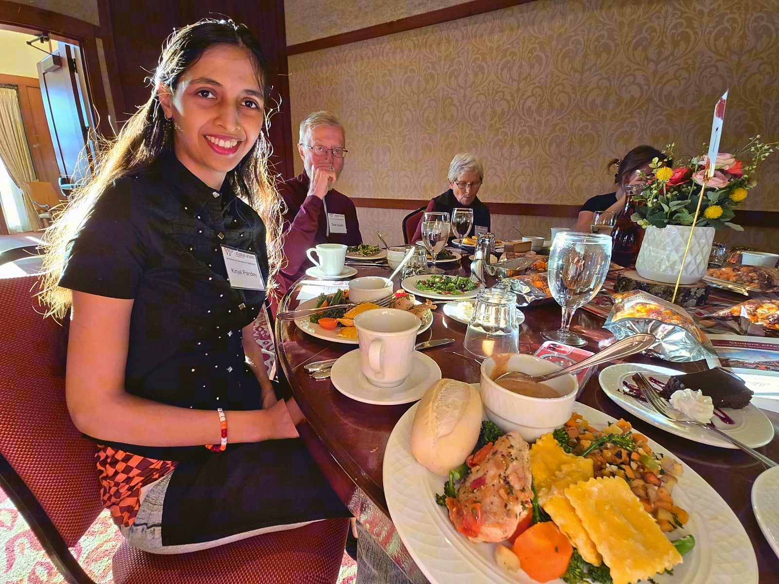 Kinjal Pandey seated with donors and guests at a Virginia Tech Student Affairs scholarship dinner