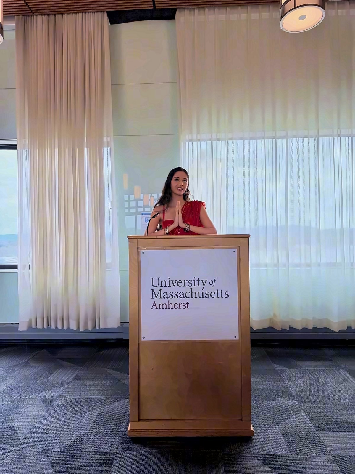 Kinjal Pandey speaking from a University of Massachusetts Amherst lectern